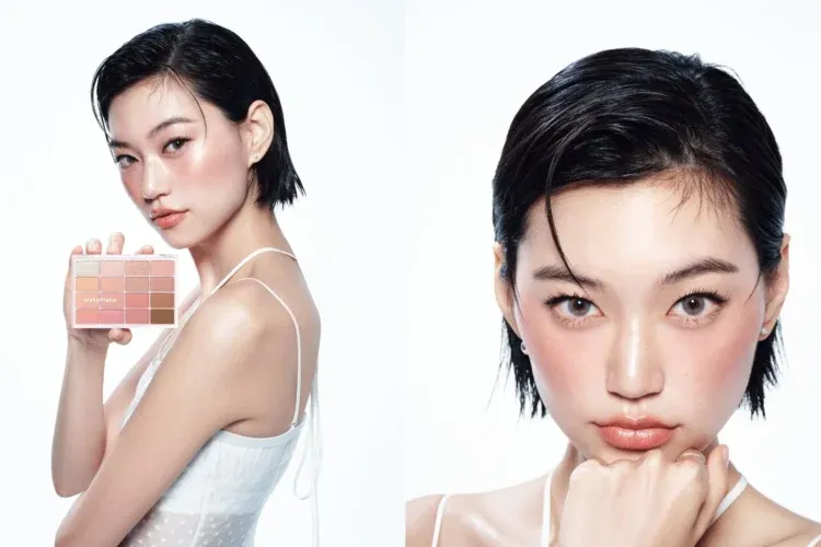 女性が化粧品パレットを持ち、顔にメイクを施している様子。